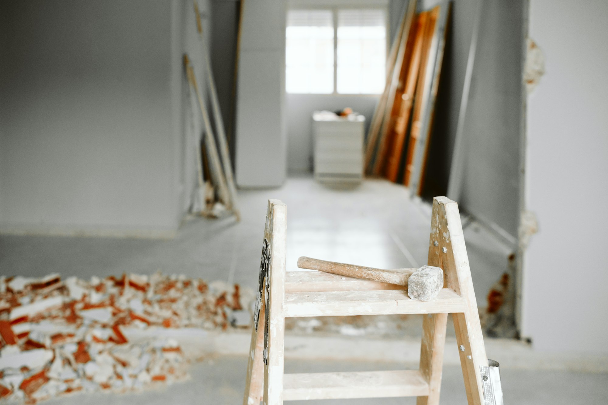 ladder, hammer and debris at home construction site. Home renovation